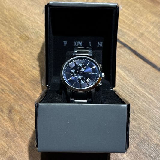 Emporio Armani watch in a black box on a wooden surface