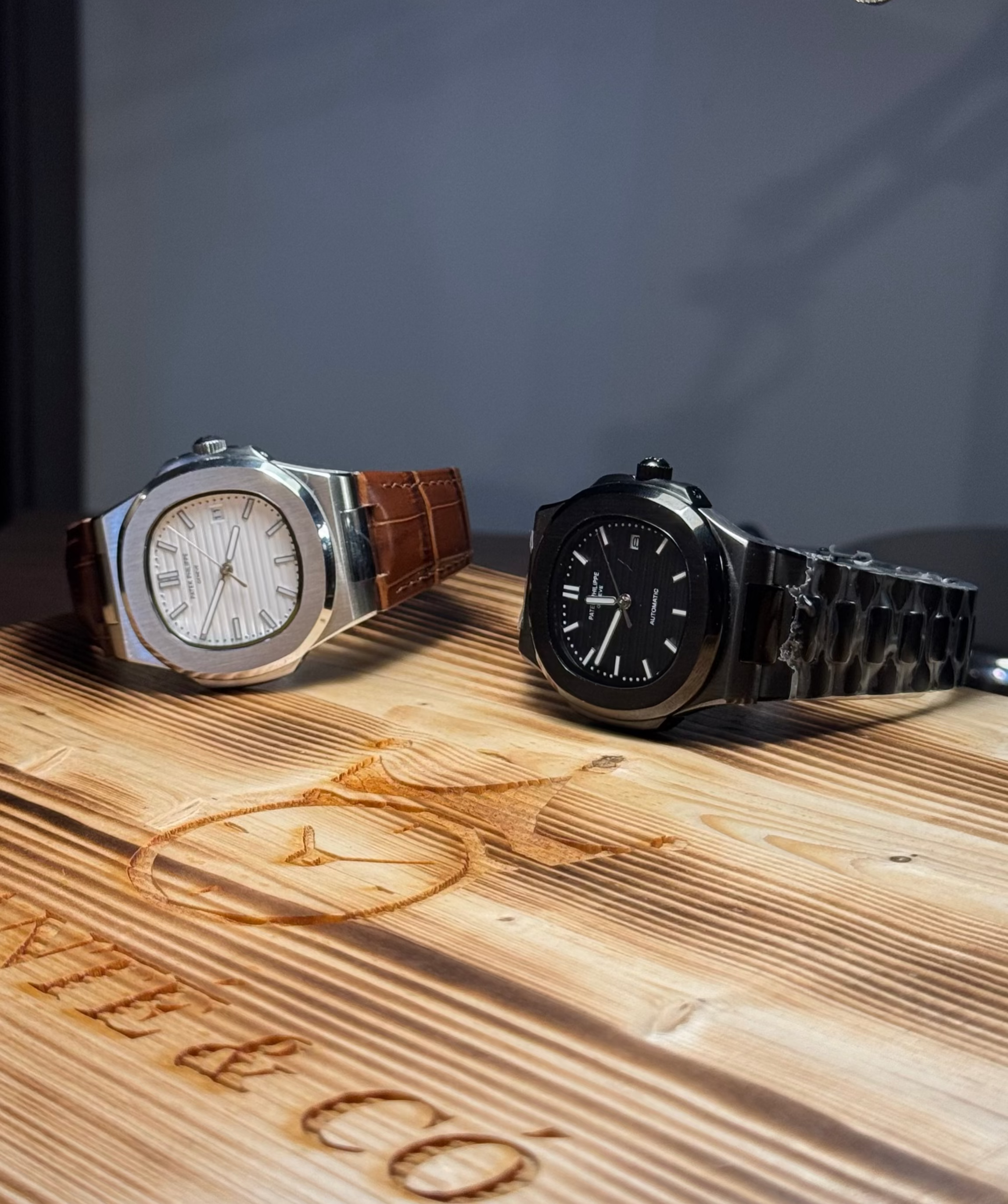 Two watches on a wooden surface with 'Bentley & Co' branding.